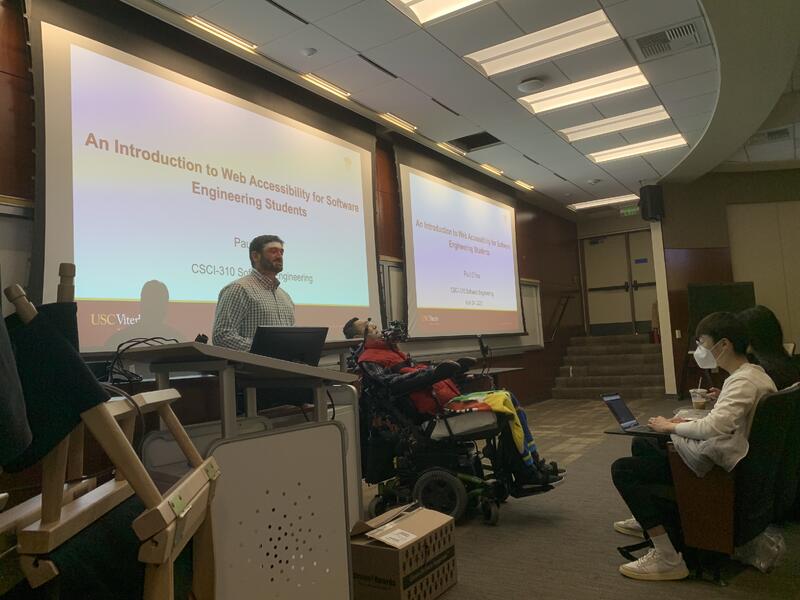 Paul in front of a class as a guess lecturer, next to his advisor (the instructor) in Spring 2023.